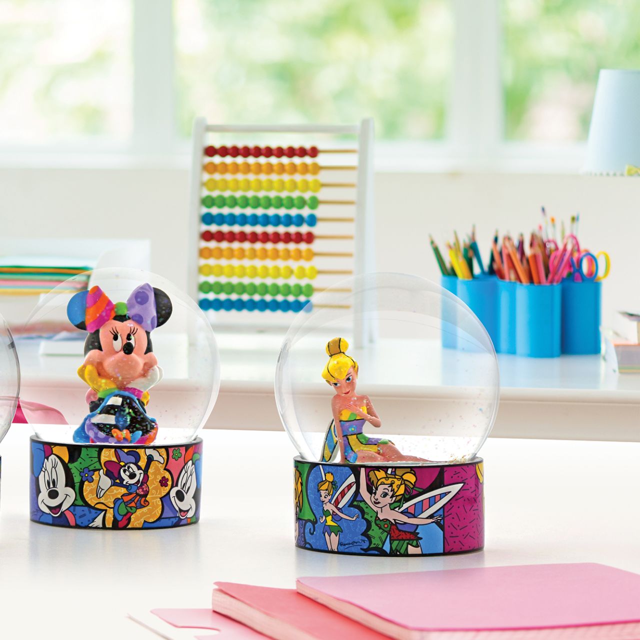 Romero Britto Tinker Bell Snow Globe  Tink, the feisty, fluttering fairy is here in a colourfully creative dreamland. Give it a shake and fly away to a magical world designed by Romero Britto.