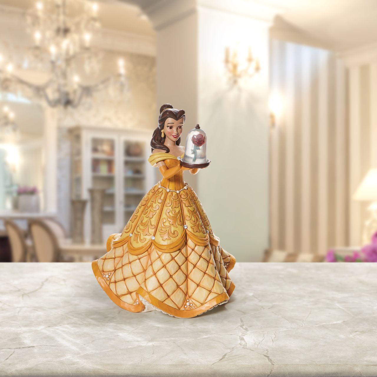 First in a Series of Deluxe figurines (The Enchanted Princess Series.) Designed by Jim Shore in celebration of Beauty and the Beast's 30th Anniversary is this striking 38.0cm Belle figurine, Belle looks stunning in her characteristic golden ball gown, embellished with pearls and swarovski crystals.