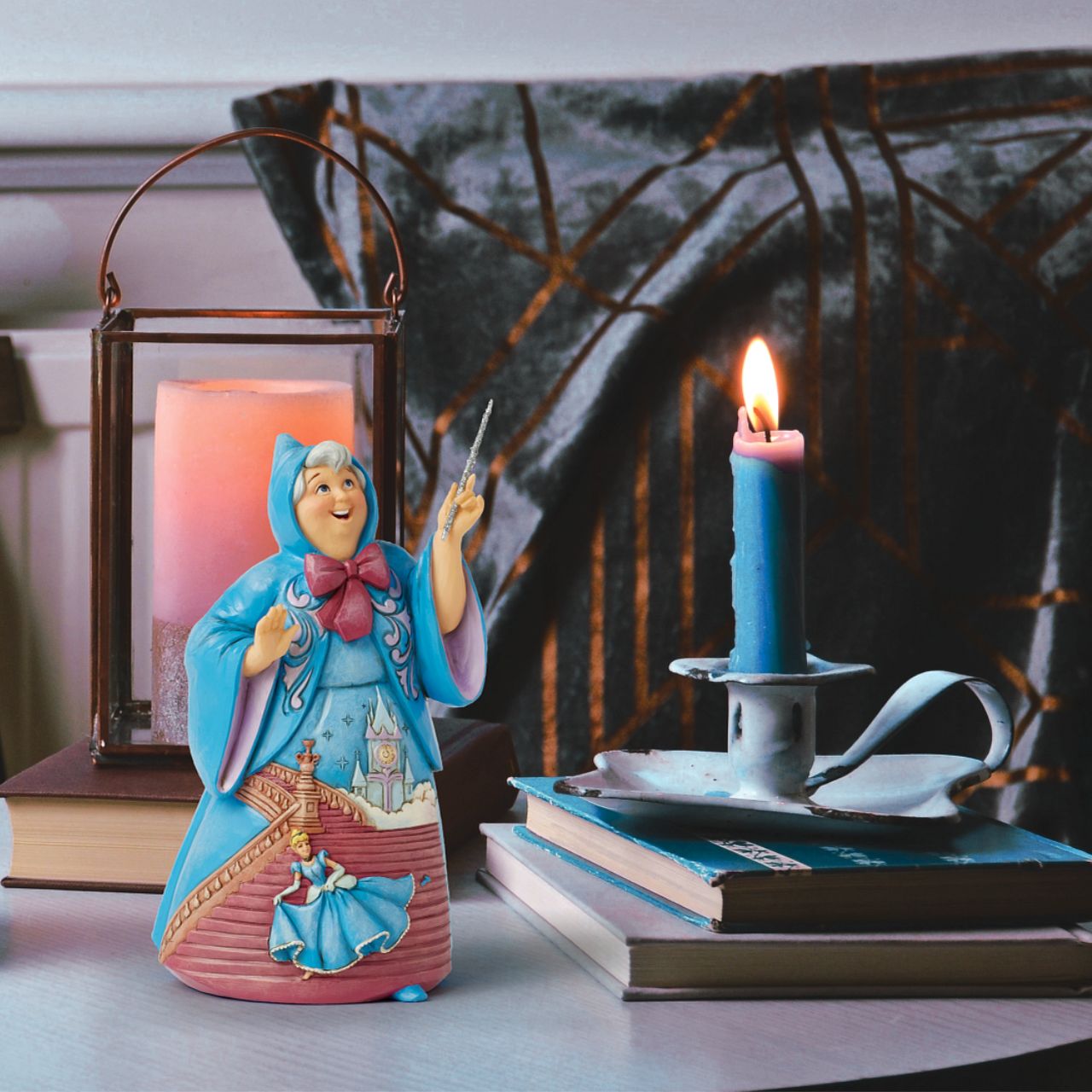 In this magical Jim Shore design, the Fairy Godmother smiles with her wand, her rosemaling blue robes parting to reveal Cinderella racing down the steps as the clock strikes midnight. This captivating moment is when she will lose her glass slipper.