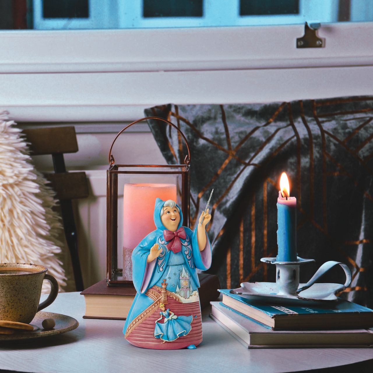 In this magical Jim Shore design, the Fairy Godmother smiles with her wand, her rosemaling blue robes parting to reveal Cinderella racing down the steps as the clock strikes midnight. This captivating moment is when she will lose her glass slipper.