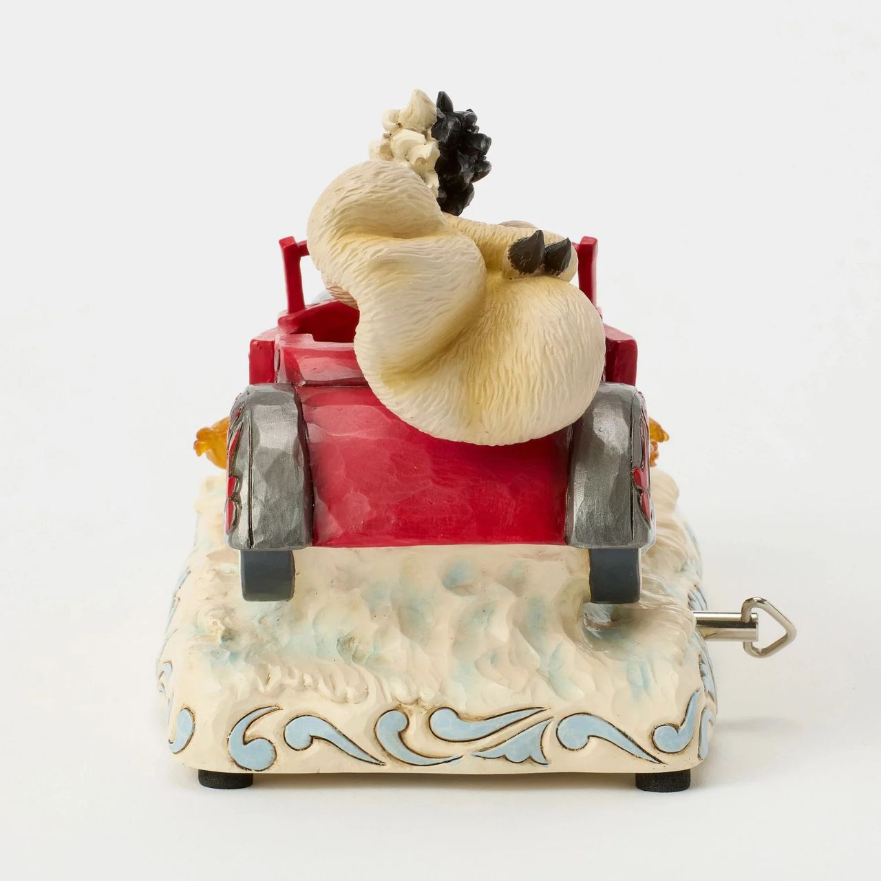 Celebrating the 65th anniversary of 101 Dalmatians, Jim Shore captures Cruella de Vil speeding in her red car adorned with rosemaling and patchwork. Flames burst from the engine as her wild hair and fur coat fly in tune to her signature melody, which is played by a wind-up key.