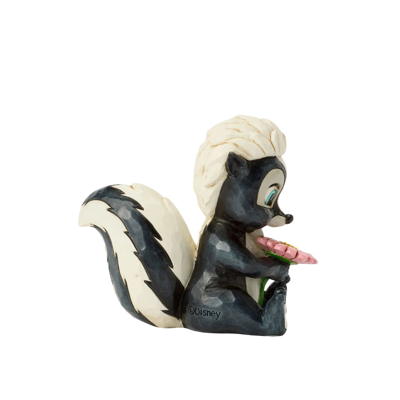 This darling Jim Shore miniature features Flower, the skunk from Bambi, adorned with striking rosemaling and holding a handful of fresh flowers. With a bright smile and childlike love, she radiates sweetness and charm.