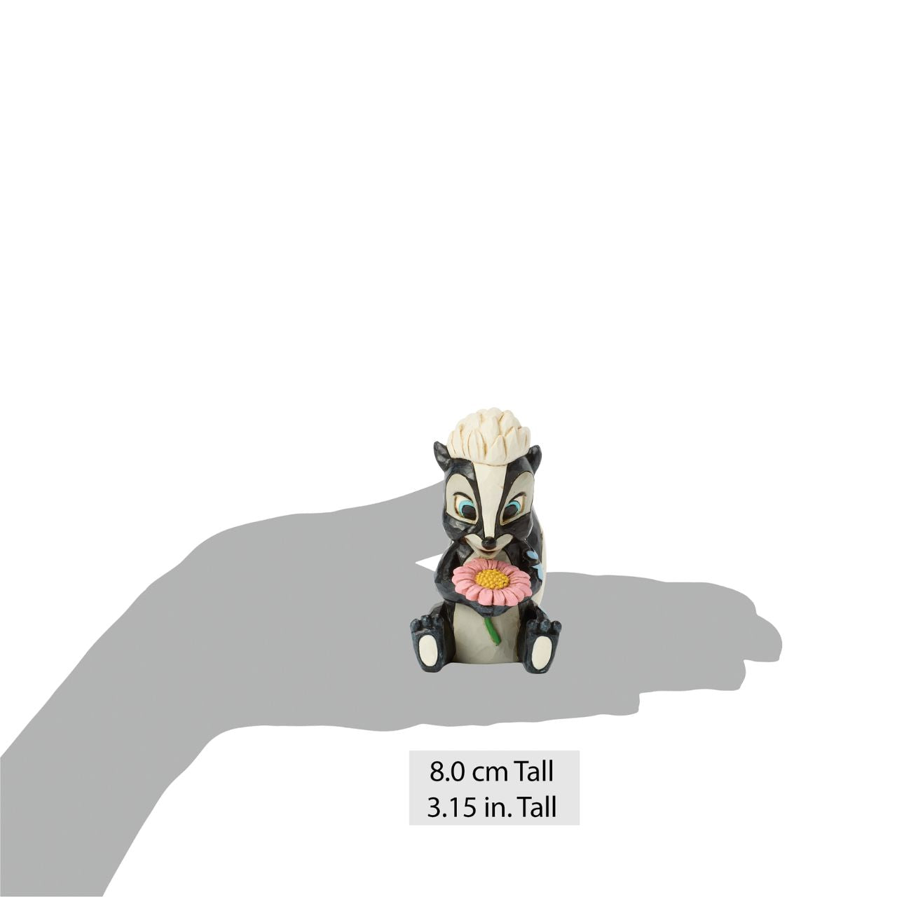 This darling Jim Shore miniature features Flower, the skunk from Bambi, adorned with striking rosemaling and holding a handful of fresh flowers. With a bright smile and childlike love, she radiates sweetness and charm.