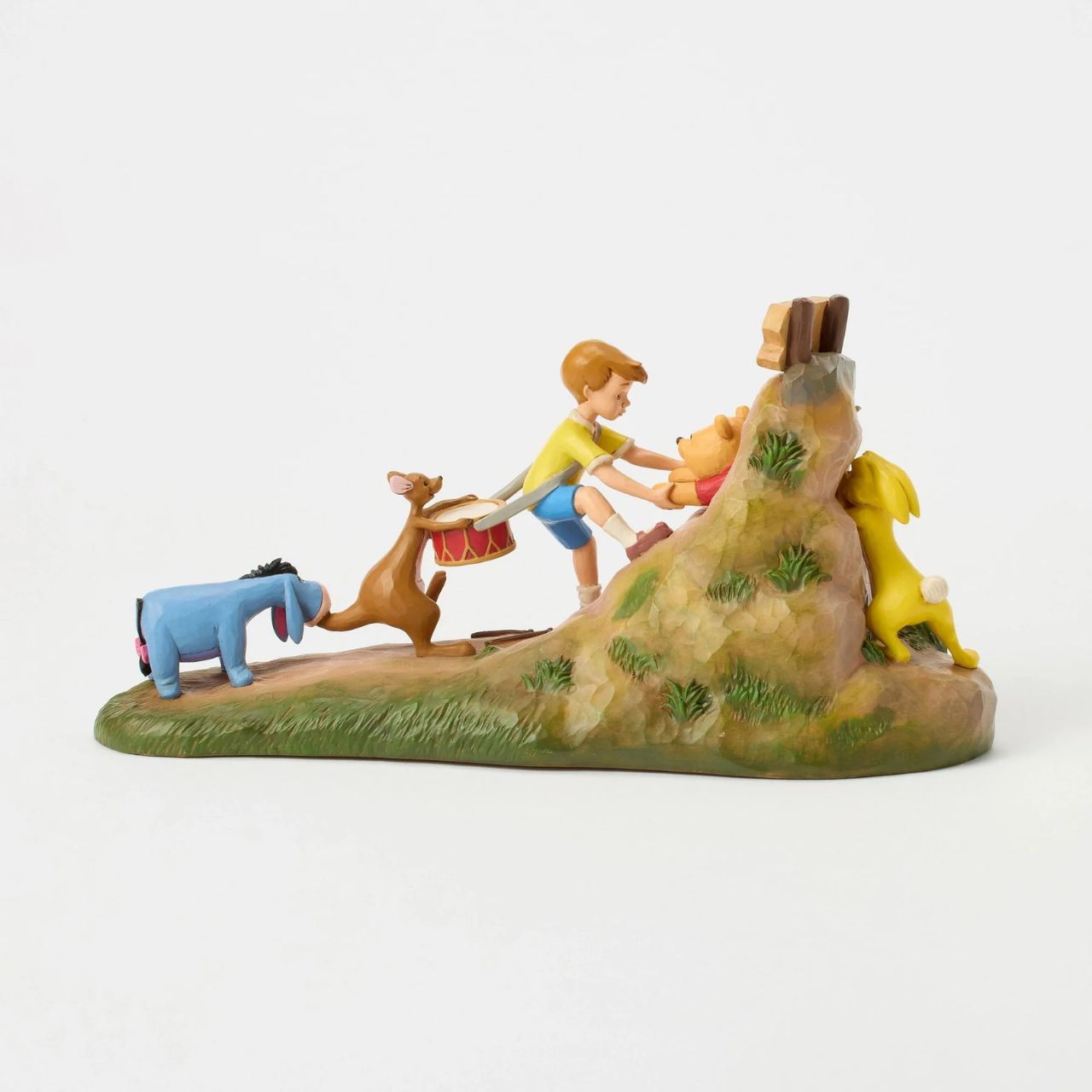 After a celebration in the Hundred Acre Wood, Pooh needs a little help exiting Rabbit's House. Christopher Robin, Kanga, and Eeyore pull Pooh's hands while Rabbit pushes from behind. Adorned with Jim Shore's iconic detailing and soft floral accents.