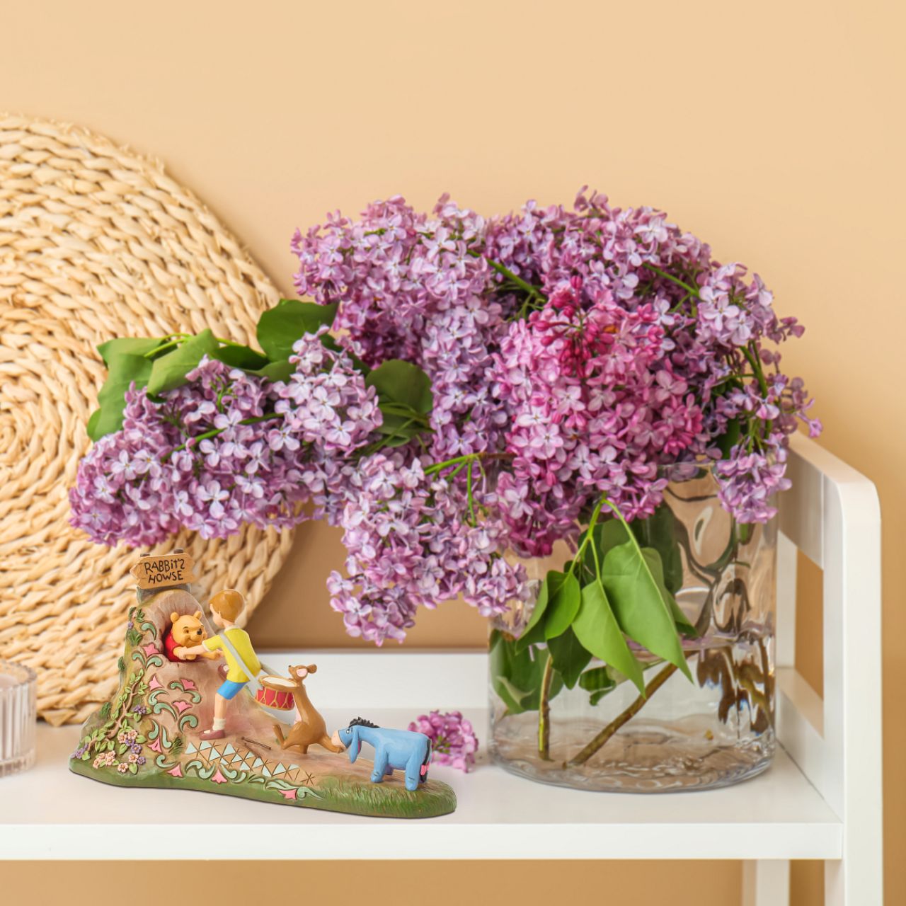 After a celebration in the Hundred Acre Wood, Pooh needs a little help exiting Rabbit's House. Christopher Robin, Kanga, and Eeyore pull Pooh's hands while Rabbit pushes from behind. Adorned with Jim Shore's iconic detailing and soft floral accents.