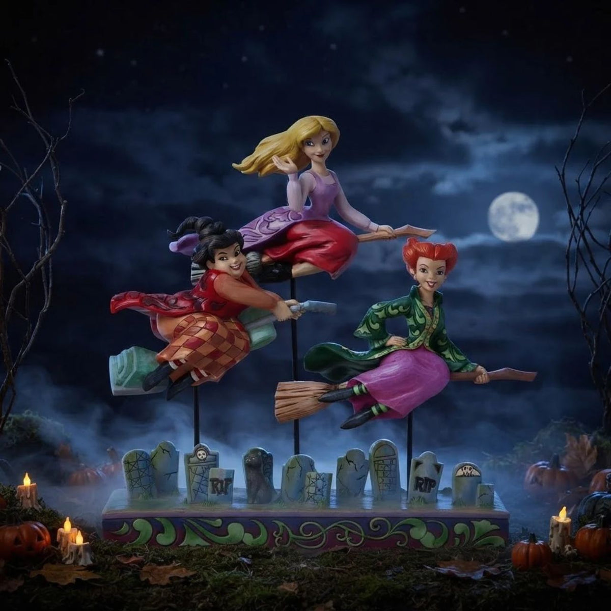 In this spellbinding Jim Shore design, the Sanderson Sisters soar on their broomsticks high above a moonlit Salem, Massachusetts. Each sister wears her iconic gown, with an expression perfectly capturing their distinct and hilarious personalities. Comes in fully branded packaging.