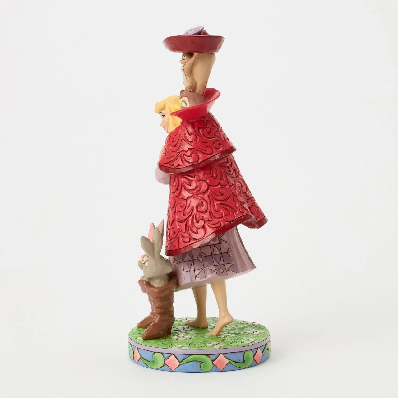Aurora's forest friends transform into a man in a red coat as she searches for her prince. An owl, squirrel, and bunnies inside boots add charm to this captivating Jim Shore design, bringing the memorable movie scene to life with enchantment.