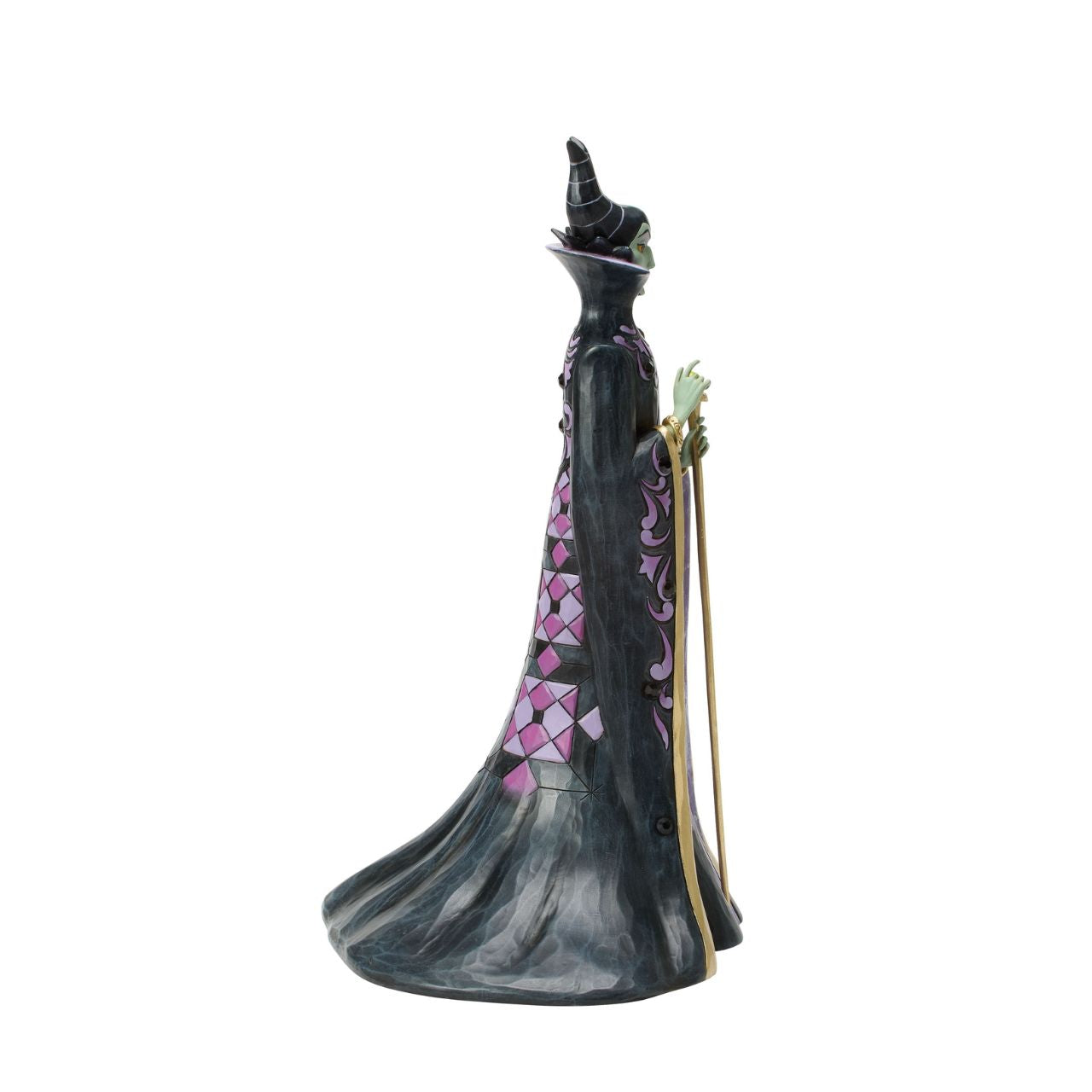This Jim Shore design captures the vengeful villainess, Maleficent, in her striking black and purple cloak adorned with Shore's quilt and rosemaling patterns. With a sinister gaze, she taps her staff, channeling dark magic with malice in her heart.