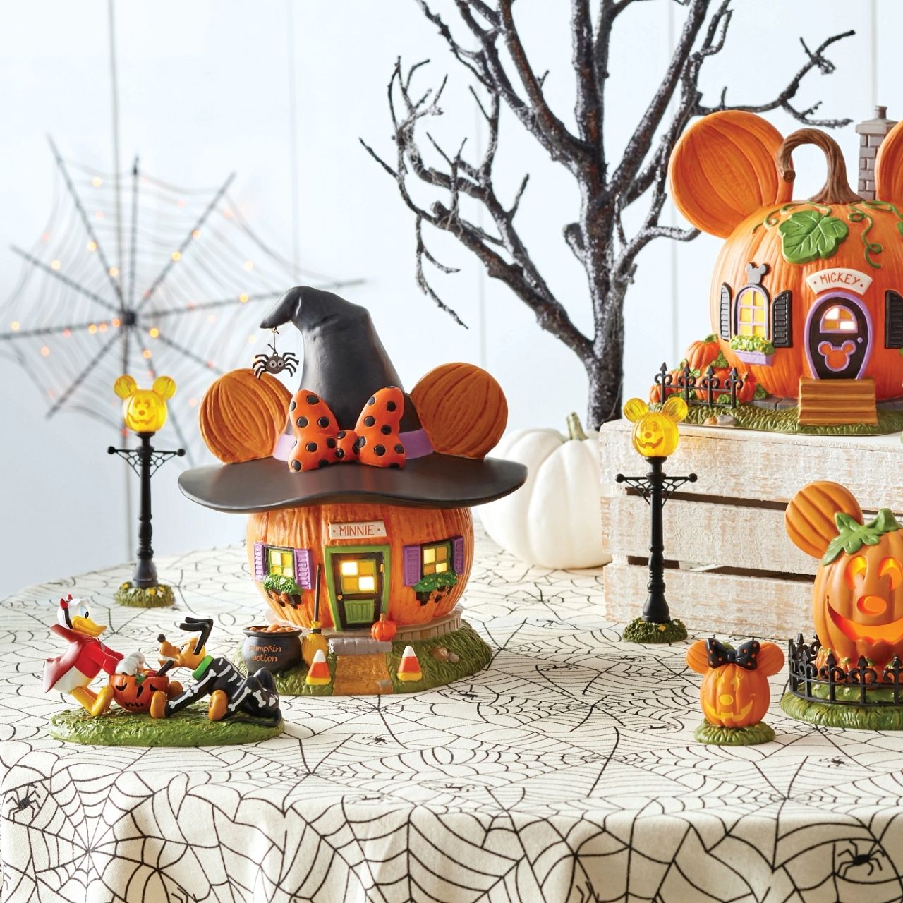 Wearing a jaunty witch's hat and her signature polka-dotted bow, Minnie's Pumpkin Town House is ready for the season!