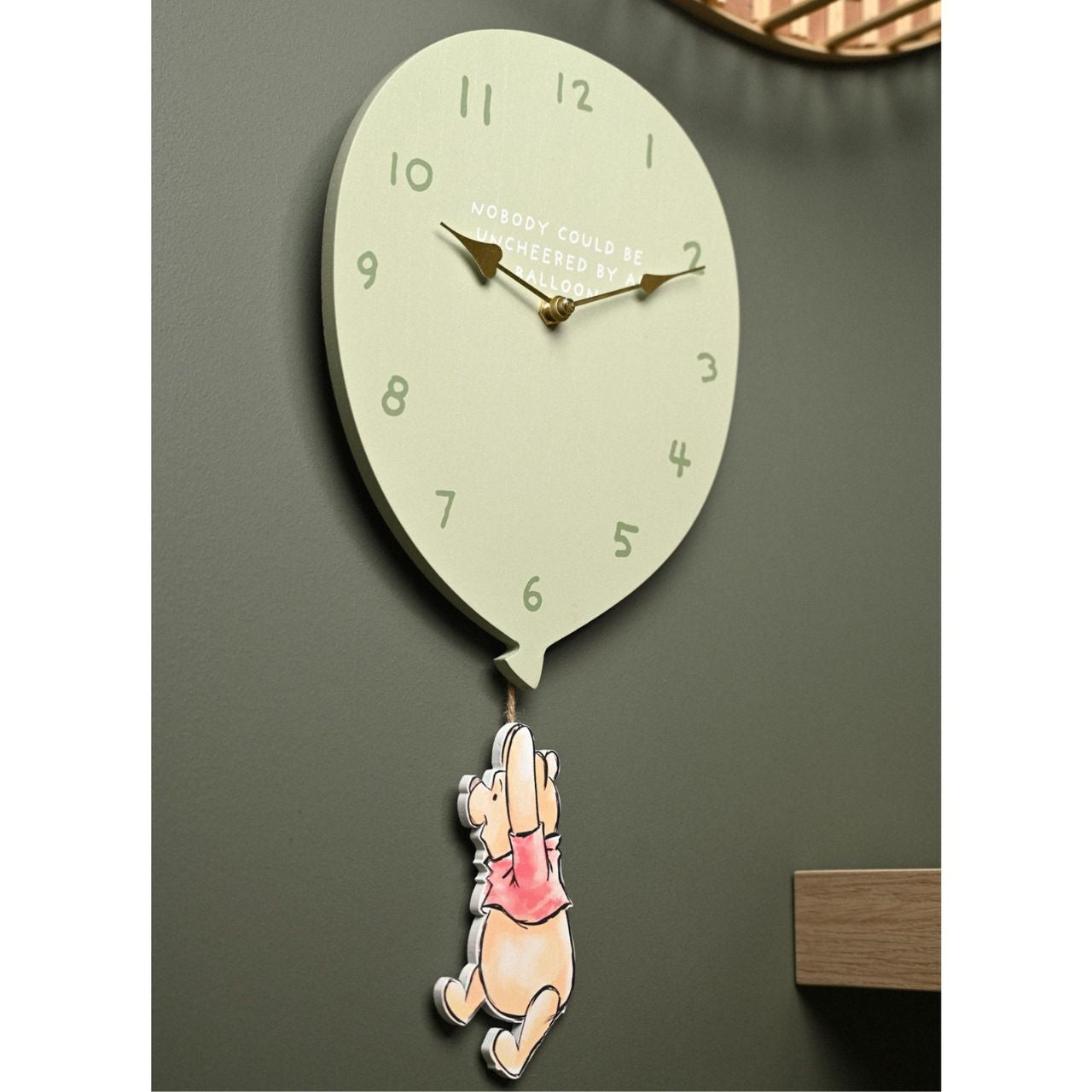 Featuring a charming illustration of Pooh Bear dangling from a balloon pendulum, this clock is sure to bring a smile to any Winnie the Pooh fan's face.