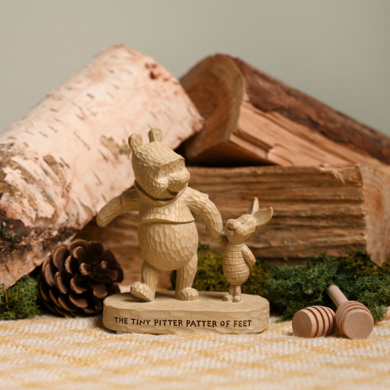 Winnie the Pooh Wood Effect Figurine "The Tiny Pitter Patter of Feet"  Bring some Disney magic to the life of your loved ones with this wonderful Pooh & Piglet figurine. Measures 12cms in height and has a width of 10cms.