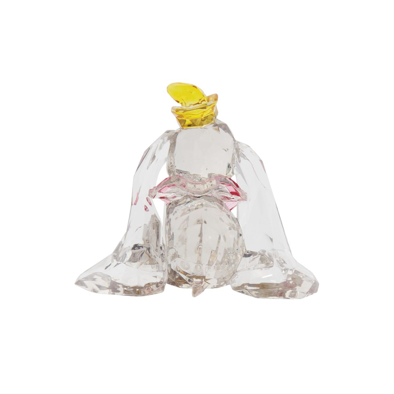 This "gem cut" acrylic sculpture reflects the ninth wonder of the universe. The world's only flying elephant. Dumbo is already for his circus debut with his yellow hat and pink collar. Presented in a branded window gift box. Not a toy or children's product. Intended for adults only.