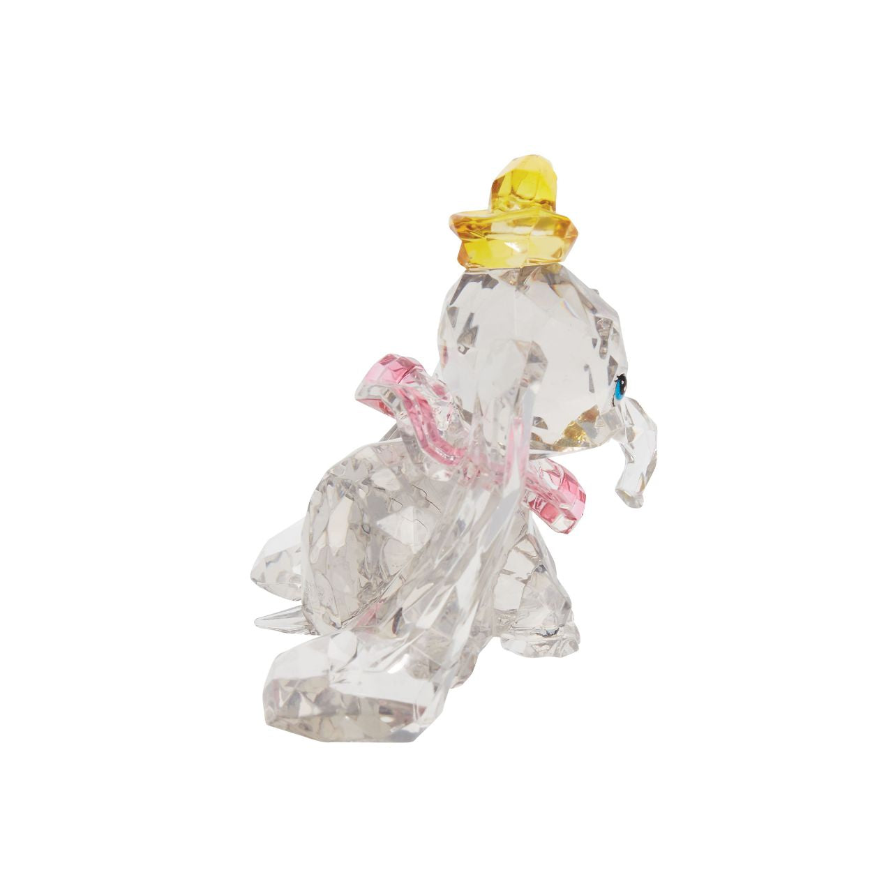 This "gem cut" acrylic sculpture reflects the ninth wonder of the universe. The world's only flying elephant. Dumbo is already for his circus debut with his yellow hat and pink collar. Presented in a branded window gift box. Not a toy or children's product. Intended for adults only.