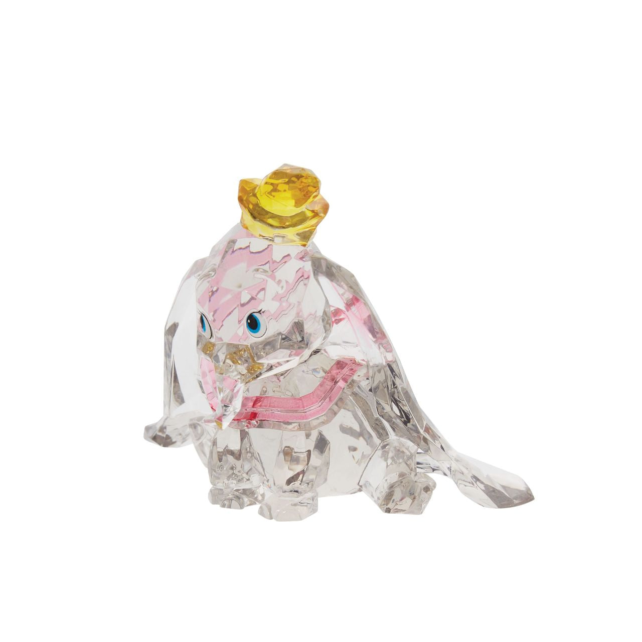 This "gem cut" acrylic sculpture reflects the ninth wonder of the universe. The world's only flying elephant. Dumbo is already for his circus debut with his yellow hat and pink collar. Presented in a branded window gift box. Not a toy or children's product. Intended for adults only.