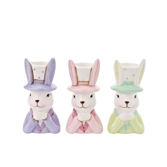 Bring a playful touch to your product line with the Eggs-traordinary Gifting Company's set of three Bunny in Top Hat Planter's Featuring adorable bunnies in three pastel colours, pink, purple and green. This charming set of planters adds a whimsical flair on their own and even more vibrancy when paired with plants or flowers.