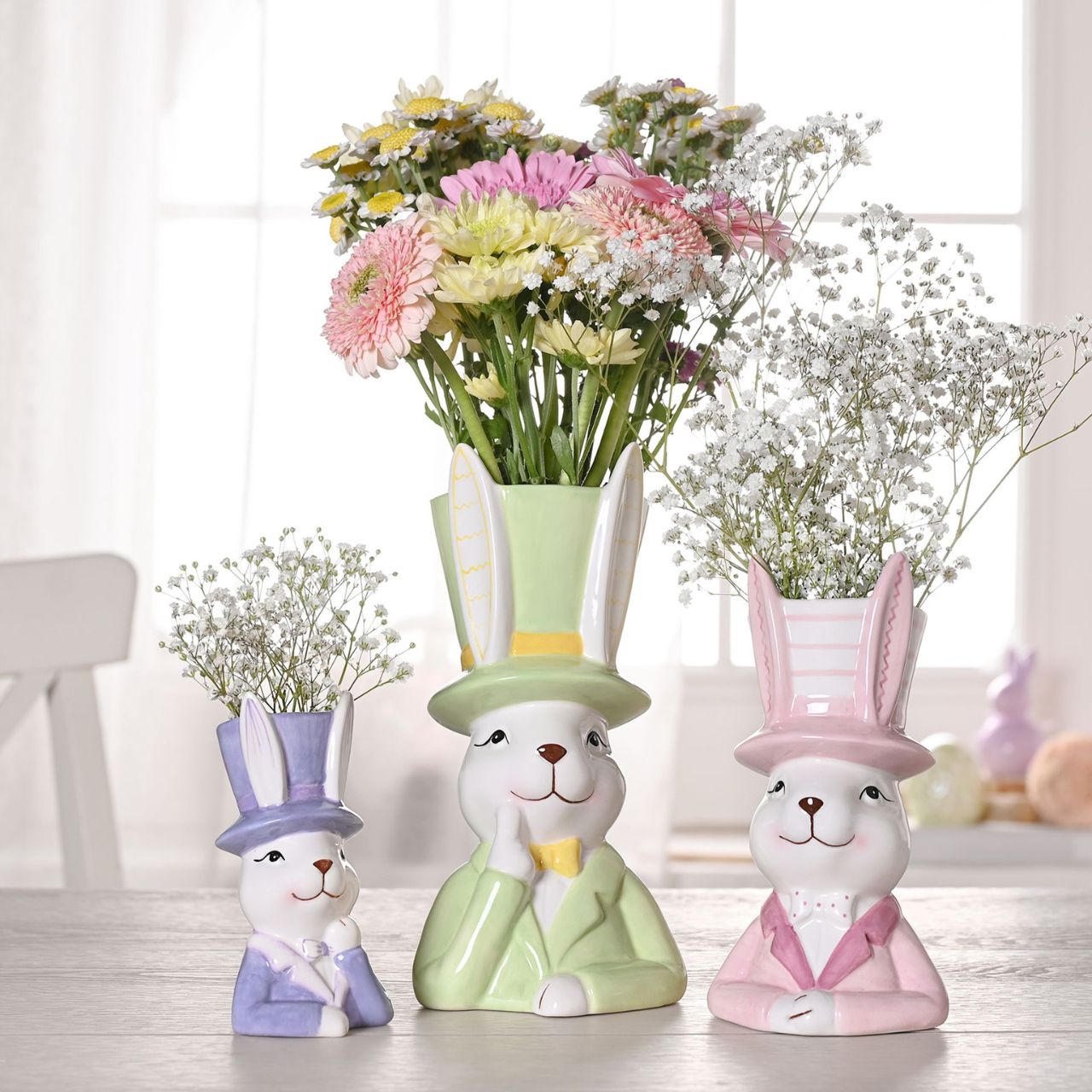 Bring a playful touch to your product line with the Eggs-traordinary Gifting Company's Bunny in Top Hat Purple Planter. Featuring an adorable bunny in pastel purple, this charming planter adds a whimsical flair on its own and even more vibrancy when paired with plants or flowers.