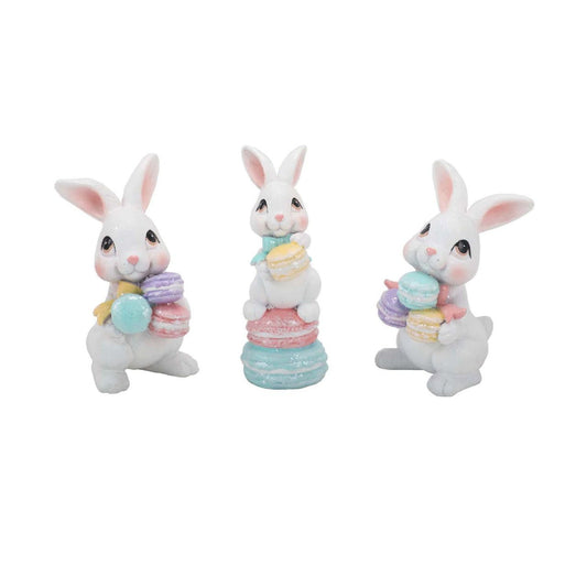 The Eggs-traordinary Gifting Co Bunny with Macarons Figurines features a playful bunny figurines each one holding a stack of pastel macarons.