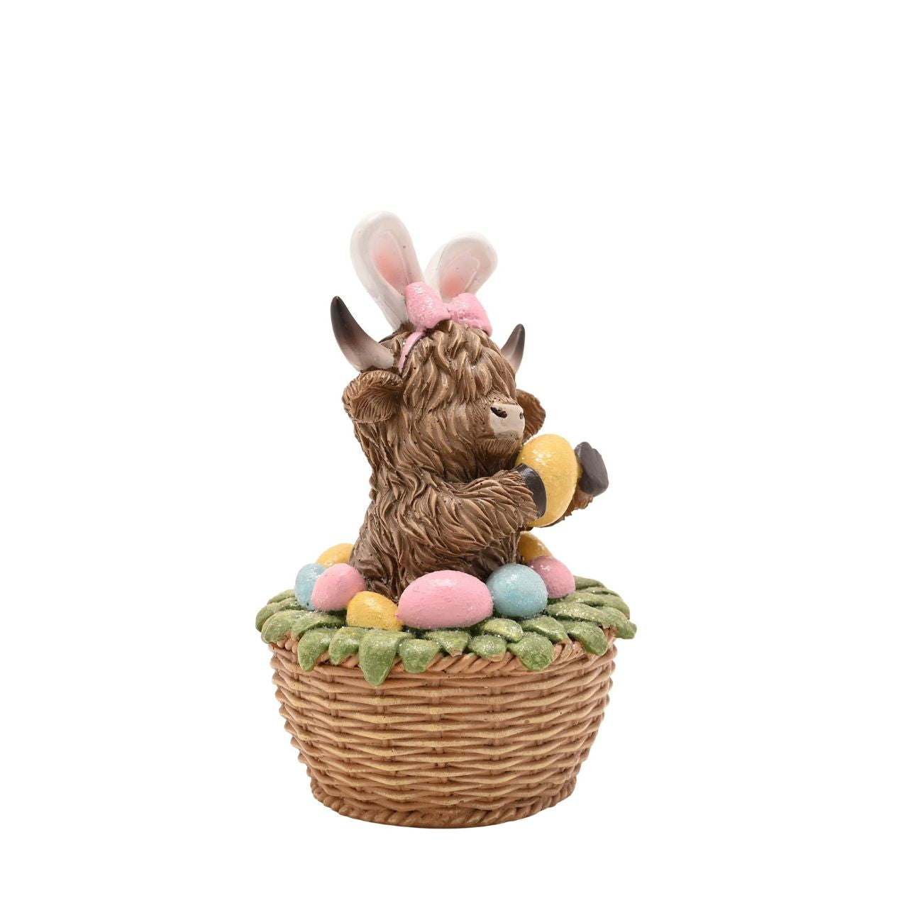 A seasonal update on a popular design, The Eggs-traordinary Gifting Co. Highland Cow in an Easter Basket figurine features the character with bunny ears.