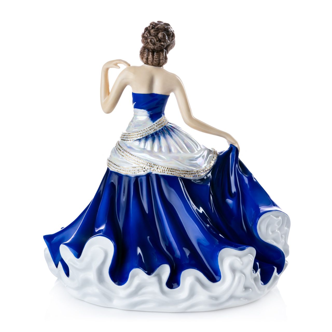 English Ladies Going to the Ball Midnight  Going to the Ball midnight is a beautifully hand-made figurine decorated in a deep royal blue colourway. This sophisticated piece is detailed with mother-of-pearl lustre and real 24-carat gold highlights that glisten when hit by the light.