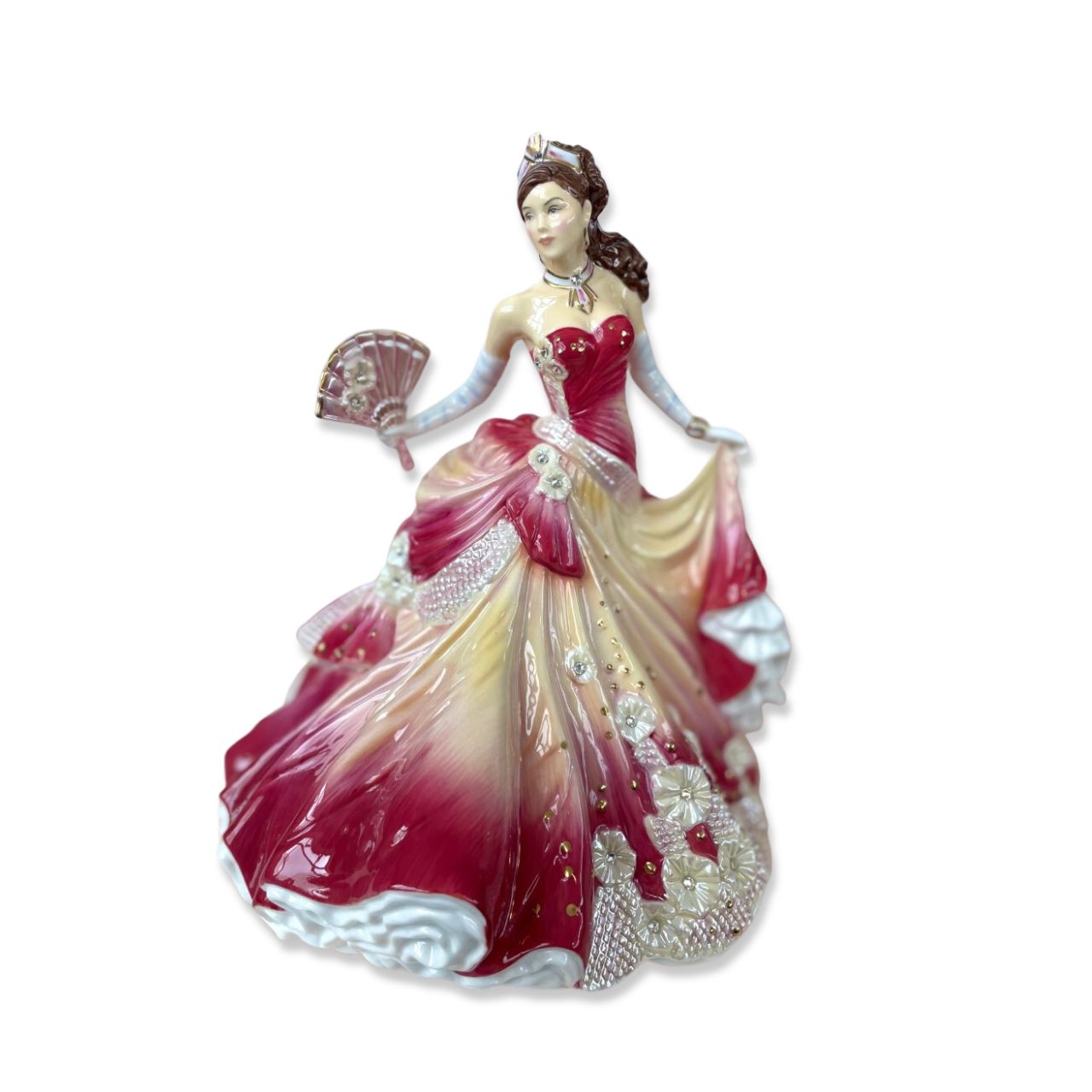 English Ladies Company Sunset Romance  Master Painter, Dan Smith felt that Valerie Annand’s stunning model of Midnight Romance was too good not to decorate again and again and again! He chose stunning reds and orange for this version, which makes a beautiful companion for the deep pink, Sweet Romance, figurine.