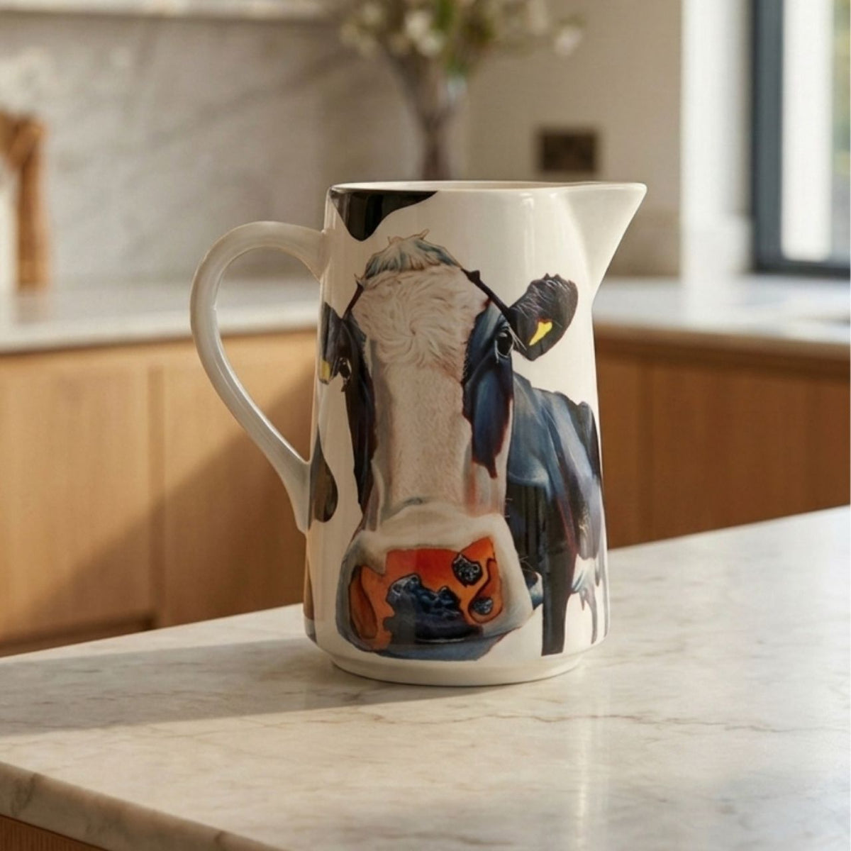 The iconic 'Tinahely Girl' artwork from Eoin O'Connor adorns this water jug 1.7 Litre volume. Made from New Bone China and presented in a beautiful cow print gift box.