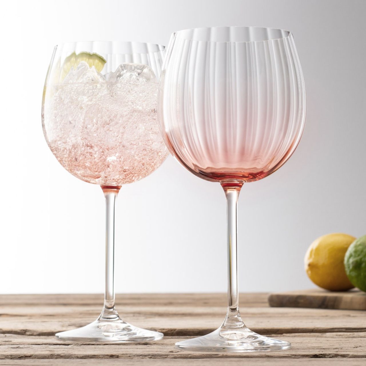 Galway Crystal Erne Gin & Tonic Glass Pair Blush  Blush colour Gin and Tonic glasses in the Erne suite from Galway Irish Crystal. Beautiful large balloon gin glasses with an elegant lines design in a light blush colour. The glass has been designed to add a splash of colour and light design to a stunning gin glass.