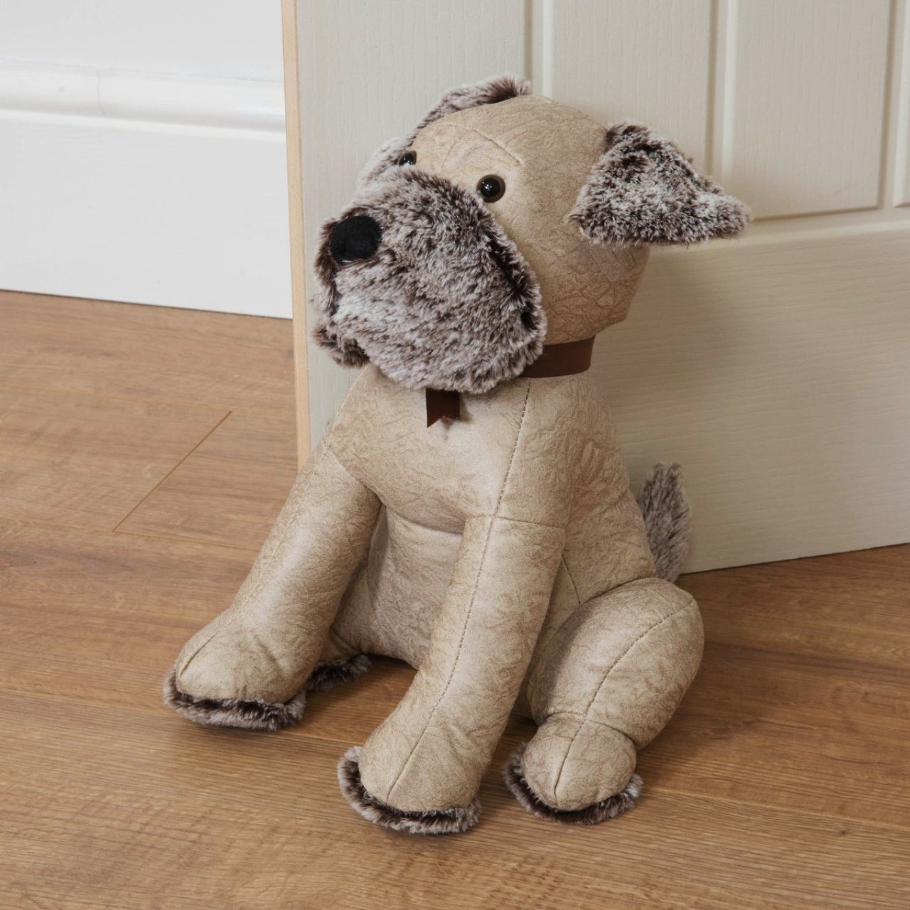 Bring some warmth and charm to any room with this distressed beige faux leather dog door stop. From the Nature Trail collection by HESTIA - bring some subtle Spring vitality to your home.