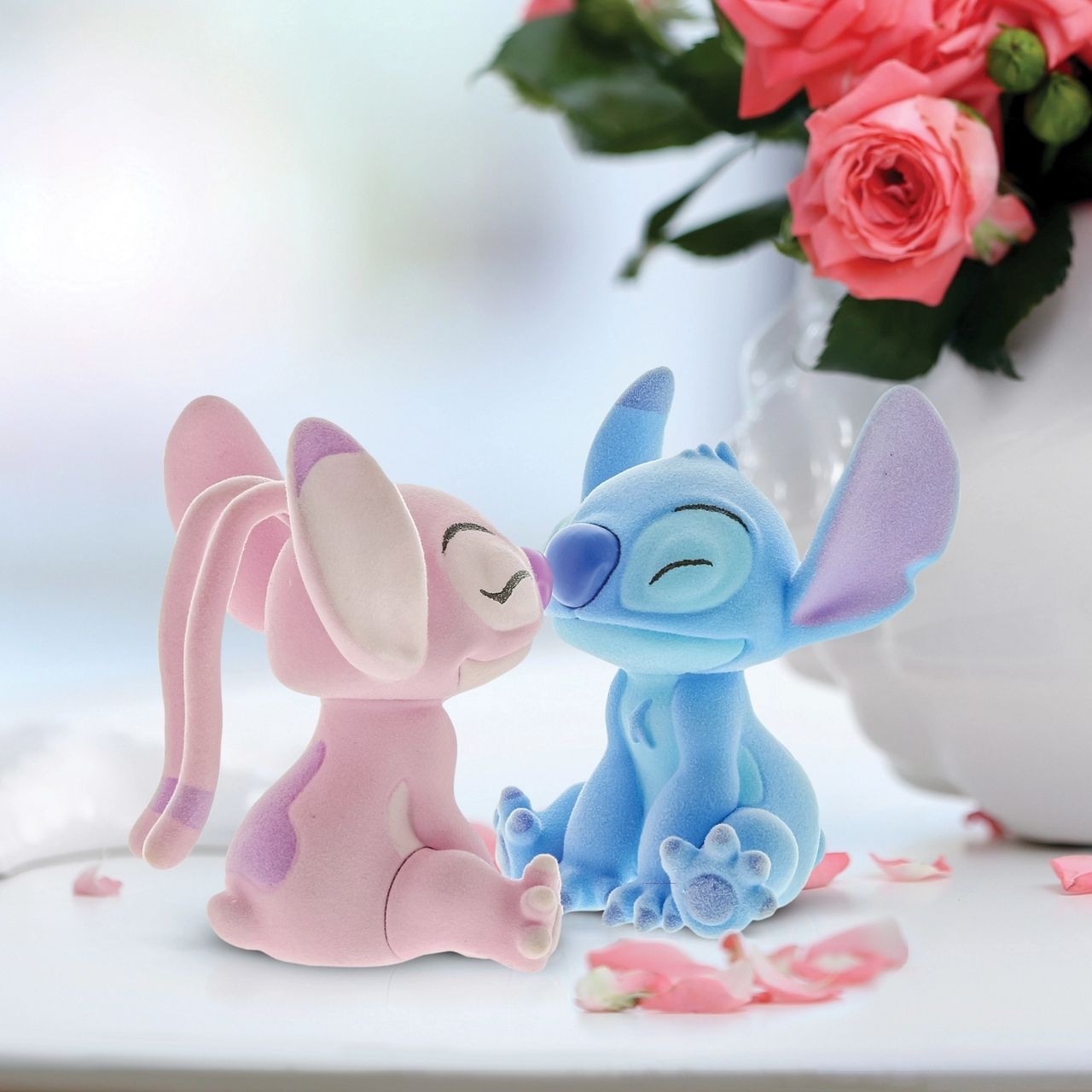 This dynamic duo are together again in this super cute flocked figurine pair. With magnets in their noses to pull them together, they look like they are having a sweet eskimo kiss.