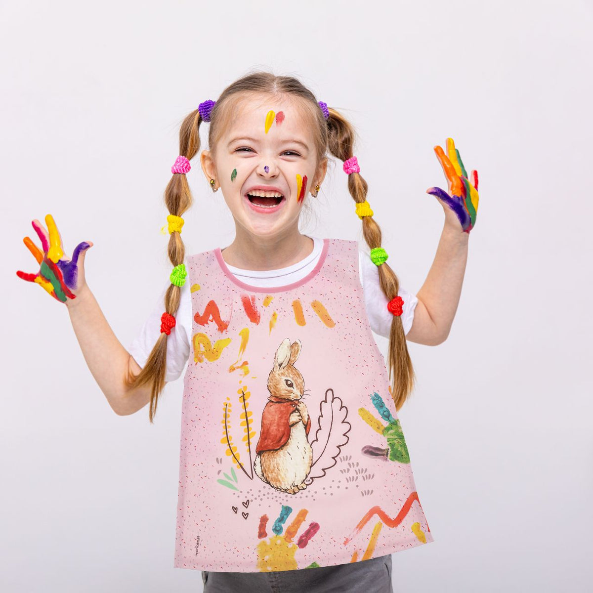 Introducing the charming Flopsy Bunny Tabard, designed with both style and practicality in mind. Featuring hook & loop tape fastening at the neck and elasticated sides, this bib is easy to put on and adjust, ensuring a snug fit for your little one. 