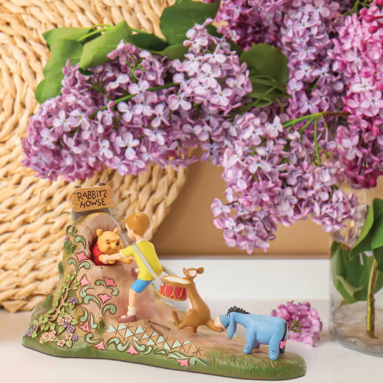 After a celebration in the Hundred Acre Wood, Pooh needs a little help exiting Rabbit's House. Christopher Robin, Kanga, and Eeyore pull Pooh's hands while Rabbit pushes from behind. Adorned with Jim Shore's iconic detailing and soft floral accents.