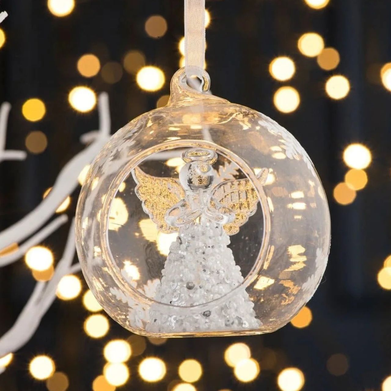 Take a peek into this magical Hanging Bauble. Featuring a sparkling Angel ready to hang on your Christmas tree. This ornament is sure to stand out on your tree. Display with other baubles from this range.