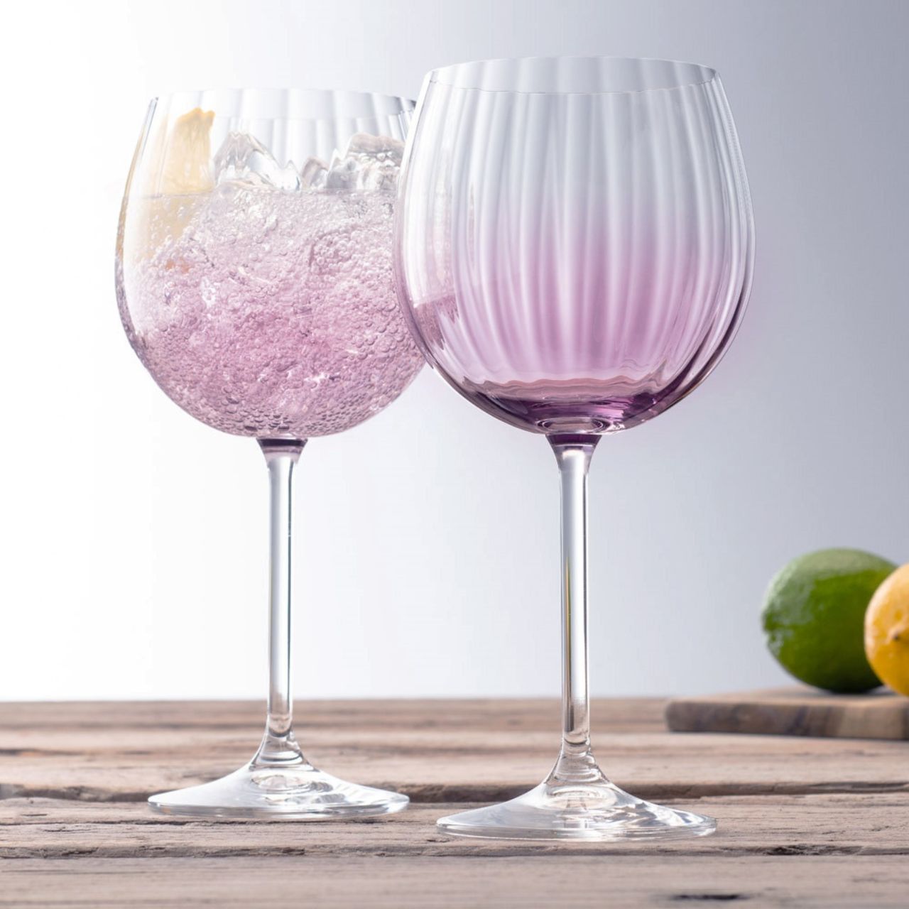 Galway Crystal Erne Gin & Tonic Pair Amethyst  Amethyst colour Gin and Tonic glasses in the Erne suite. Beautiful large balloon gin glasses with elegant lines design in an Amethyst colour. The glass has been designed to add a splash of colour and light design to a stunning gin glass.
