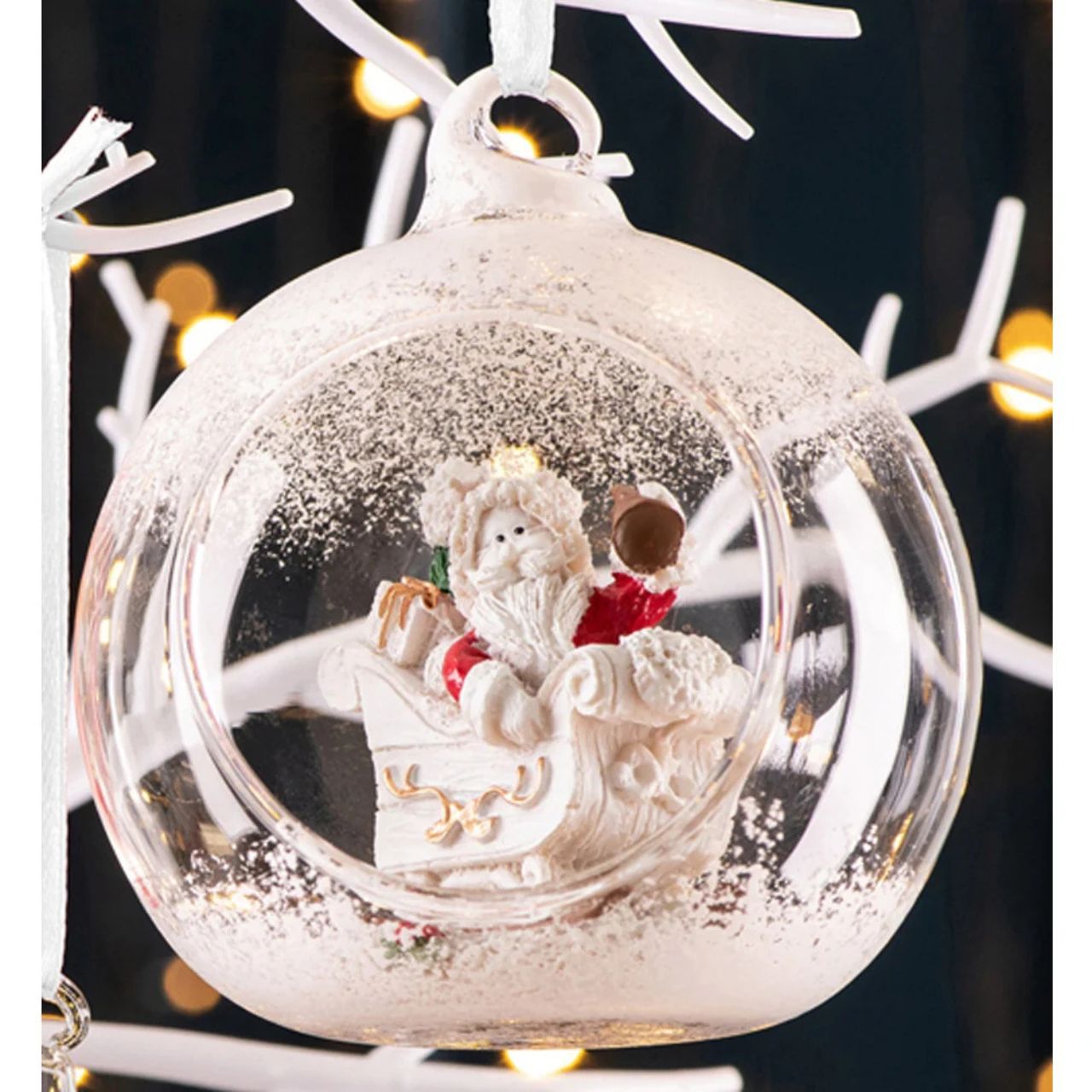 Take a peek into this magical Hanging Bauble. Featuring a jolly Santa in his Sleigh ready to deliver lots of Christmas presents. Ready to hang this ornament is sure to stand out on your tree. Display with other baubles from this range.
