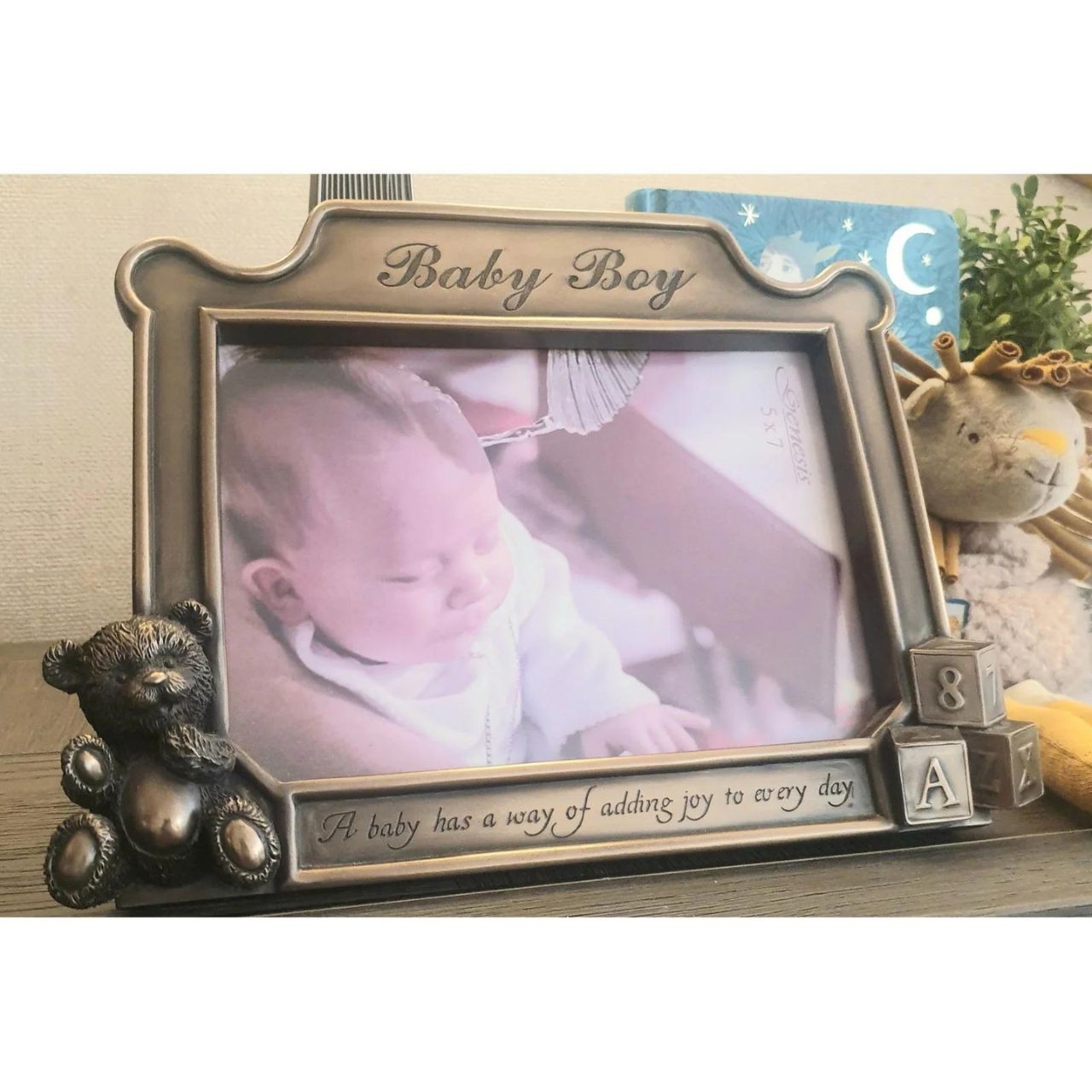This beautiful photo frame comes with the message inscribed on the front ; "A baby has a way of adding joy to every day." The perfect gift for a new arrival or christening. It holds 5 x 7 photos, and is made of cold cast bronze, measuring; an overall 7" x 9''.