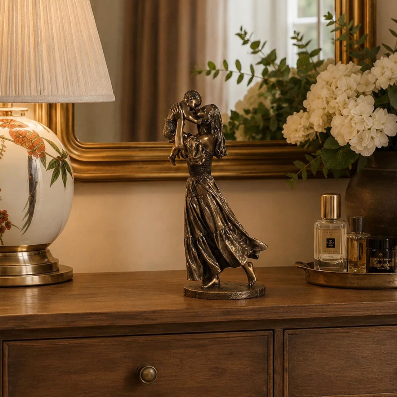 Celebrate the bond of motherhood with this heart-warming sculpture. It features a mother joyfully lifting her child in the air, capturing a moment of pure love and connection. A beautiful addition to any home or office décor.
