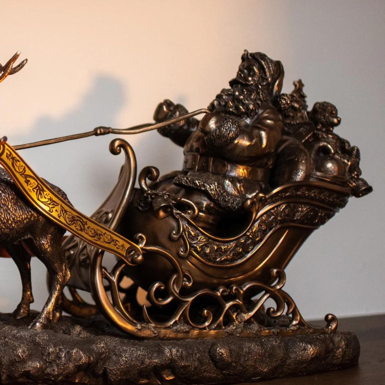 Santa on Sleigh by Genesis  Beautifully crafted from cast bronze and handcrafted, this Santa on Sleigh sculpture will make a beautiful addition to your home during the holidays. Intricately detailed, this Santa Claus features three reindeer's pulling his sleigh.