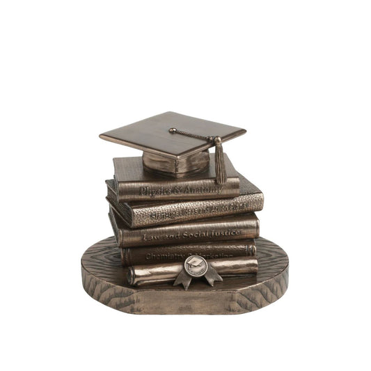 Celebrate academic achievement with this timeless Graduation Cap &amp; Books Sculpture. The piece showcases a stacked arrangement of textbooks each titled with inspirational subjects like Physics & Anatomy, Law and Social Justice, and Start-ups & Action Plans.