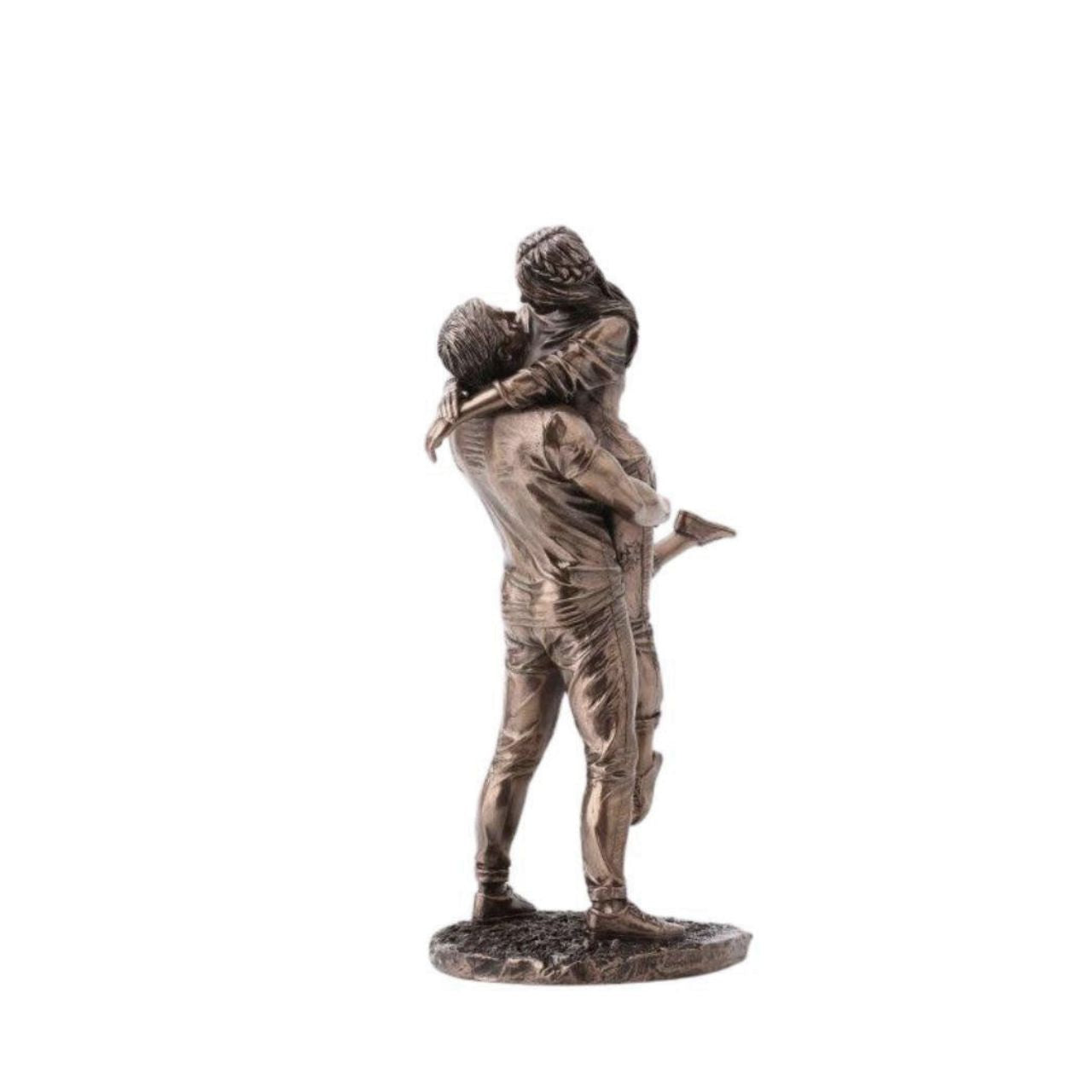 A beautiful bronze coloured statue of a couple in a loving embrace.