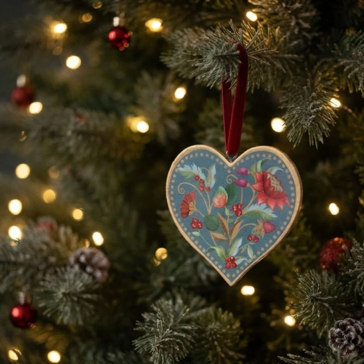 Bring festive charm to your tree with this exquisite Gisela Graham Blue Floribunda Heart &amp; Star Hanging Ornament. Crafted from 100% tin, this delicate piece features intricate blue floribunda detailing in a charming dual design—choose between a heart or star shape to suit your décor style.