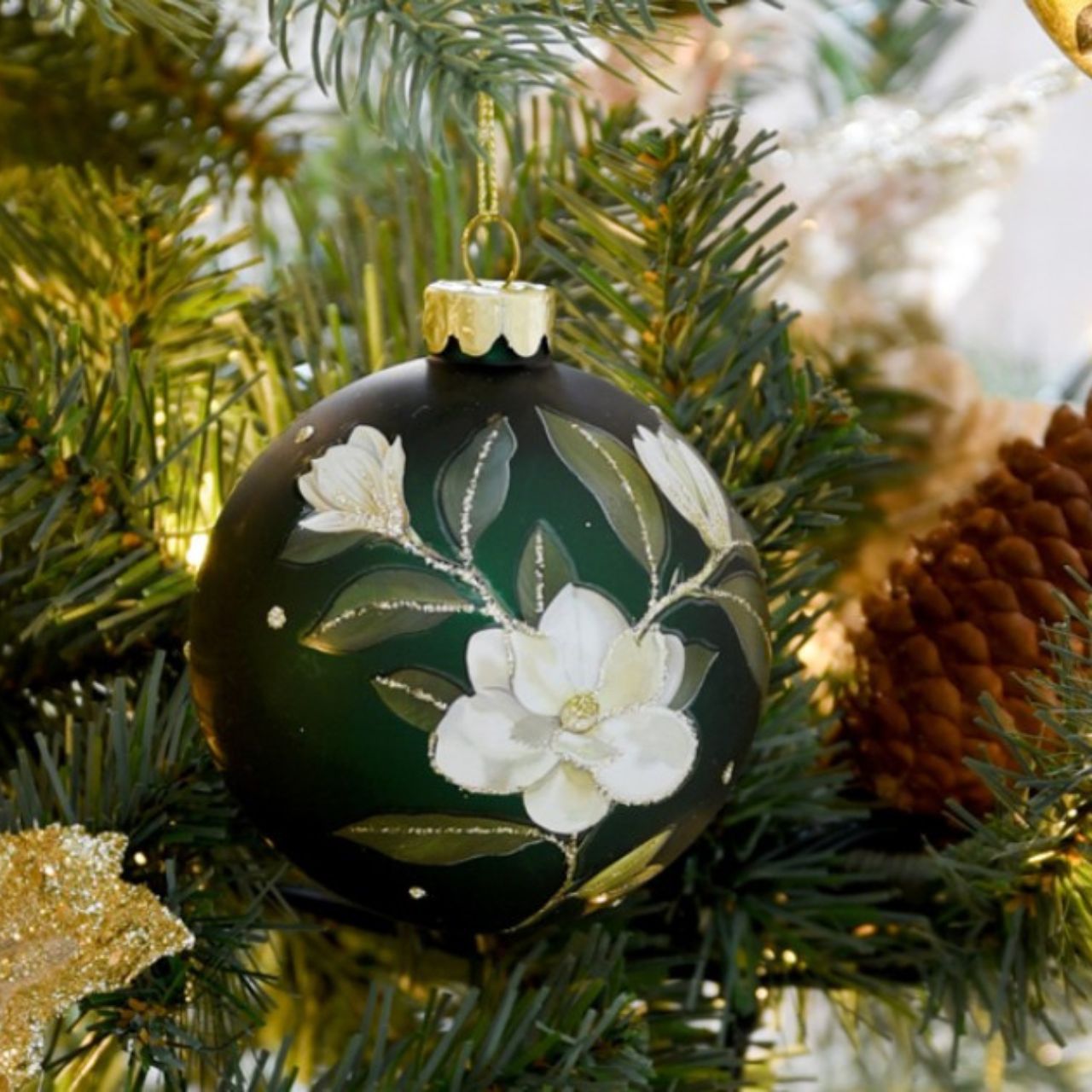 Gisela Graham Green Glass Magnolia Christmas Bauble  This stunning Gisela Graham Green Glass Magnolia Christmas Bauble adds a festive touch to any holiday décor. Decorated with intricate Magnolia details, it is the perfect addition to any Christmas tree.