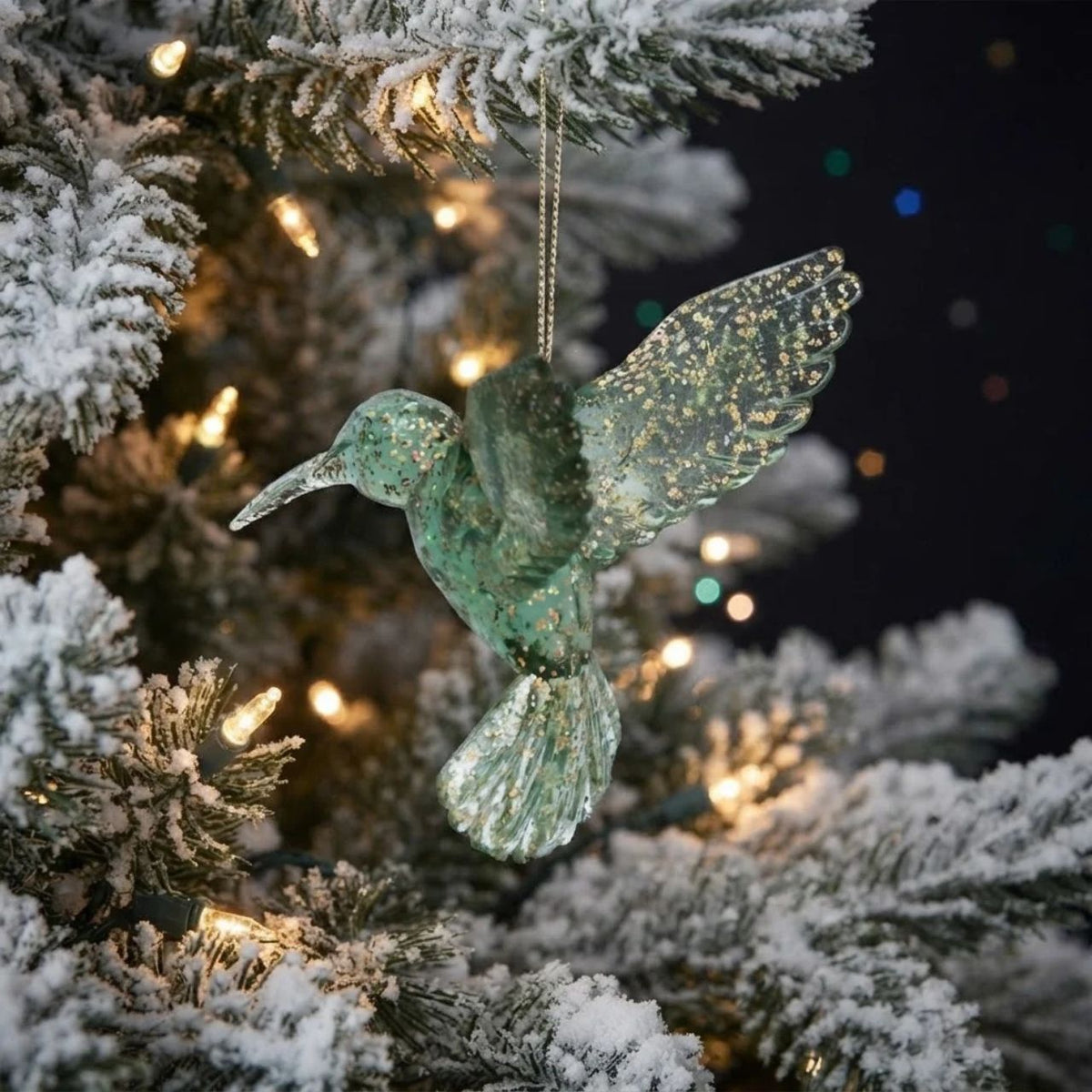 Bring a dash of holiday cheer to your Christmas tree with this stunning Green & Gold Hummingbird Ornament from Gisela Graham.