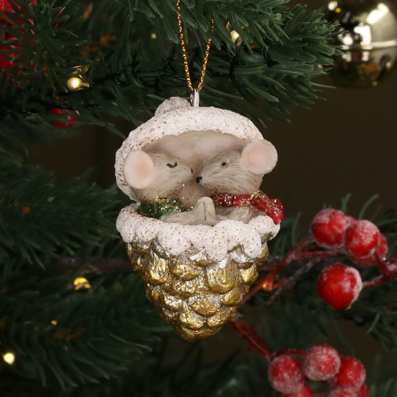 Add a touch of whimsy to your holiday décor with the Gisela Graham Mice in Gold Cone Christmas Hanging Ornament. Crafted with sparkling gold details, these charming mice will delight all who see them. Perfect for adding a unique and festive touch to your Christmas tree.
