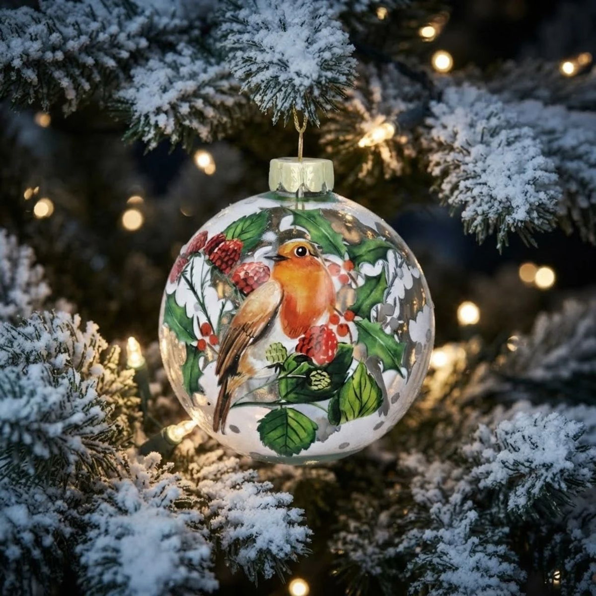 Elevate your festive décor with the Gisela Graham Robin & Holly with Fruit Clear Christmas Bauble. This delicately crafted ornament features a charming robin perched amidst holly leaves and vibrant fruit, encased in a clear, glossy bauble.