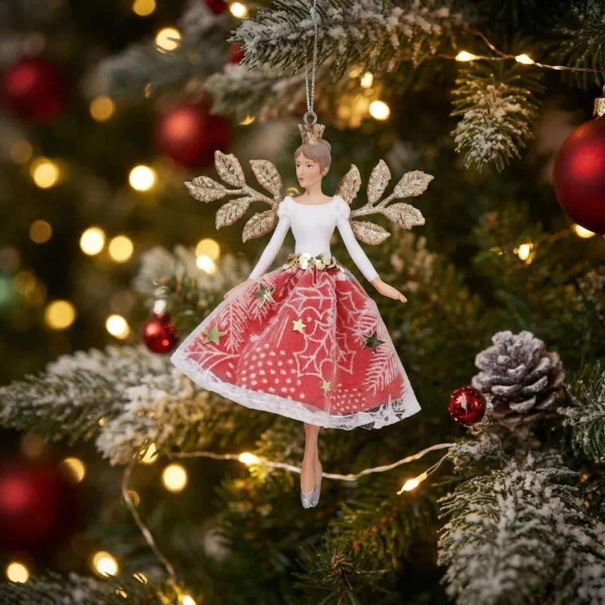Bring enchantment to your festive décor with this charming Gisela Graham White and Red Fairy Hanging Ornament. Crafted from a durable blend of resin and polyester, this delicate fairy figure features striking white and red colouring that adds a whimsical touch to any Christmas tree or seasonal display.