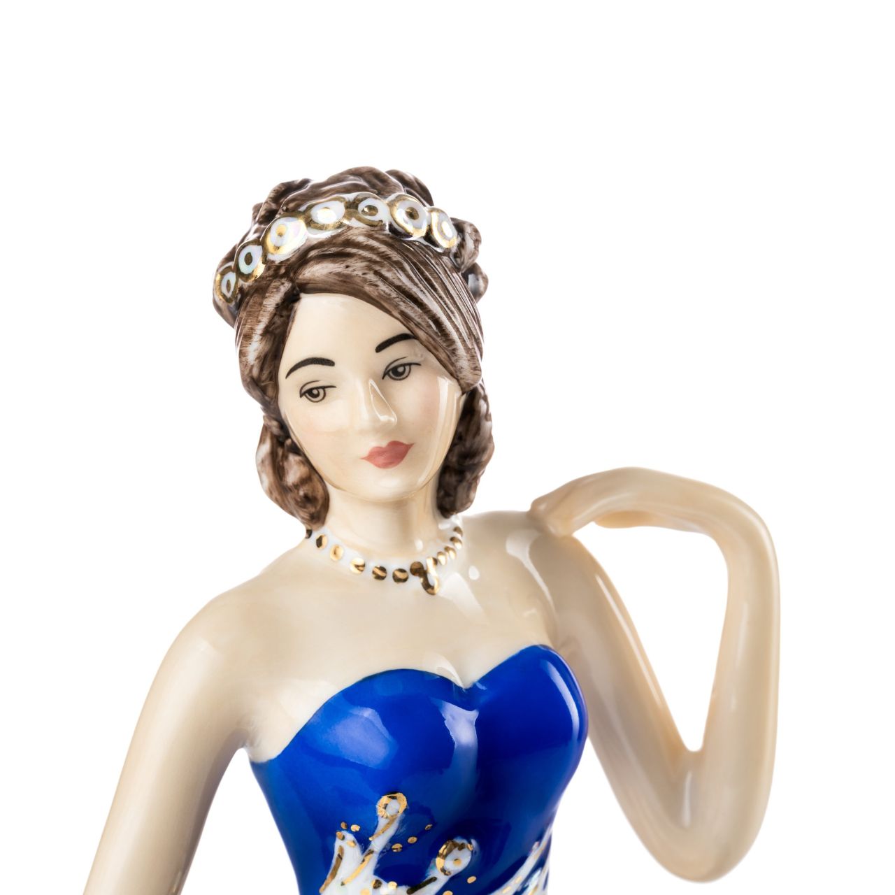 English Ladies Going to the Ball Midnight  Going to the Ball midnight is a beautifully hand-made figurine decorated in a deep royal blue colourway. This sophisticated piece is detailed with mother-of-pearl lustre and real 24-carat gold highlights that glisten when hit by the light.