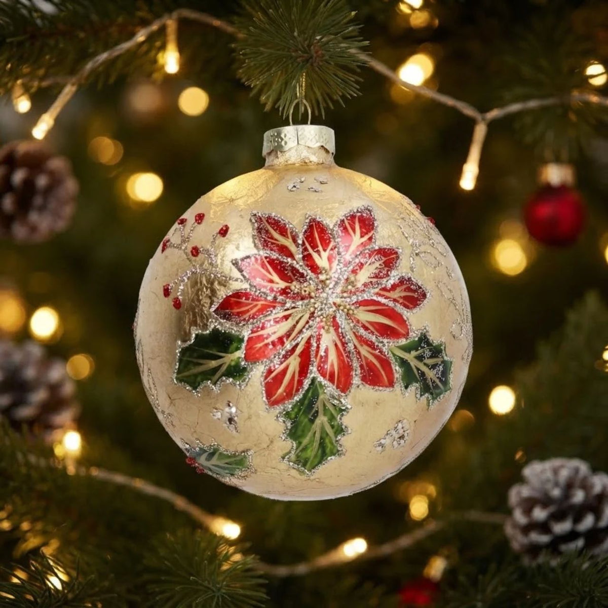Bring timeless elegance to your Christmas tree with this stunning Gisela Graham Gold Foil Poinsettia Glass Bauble. Hand-decorated with luxurious gold foil detailing, the iconic poinsettia design captures festive beauty in a classic spherical shape.