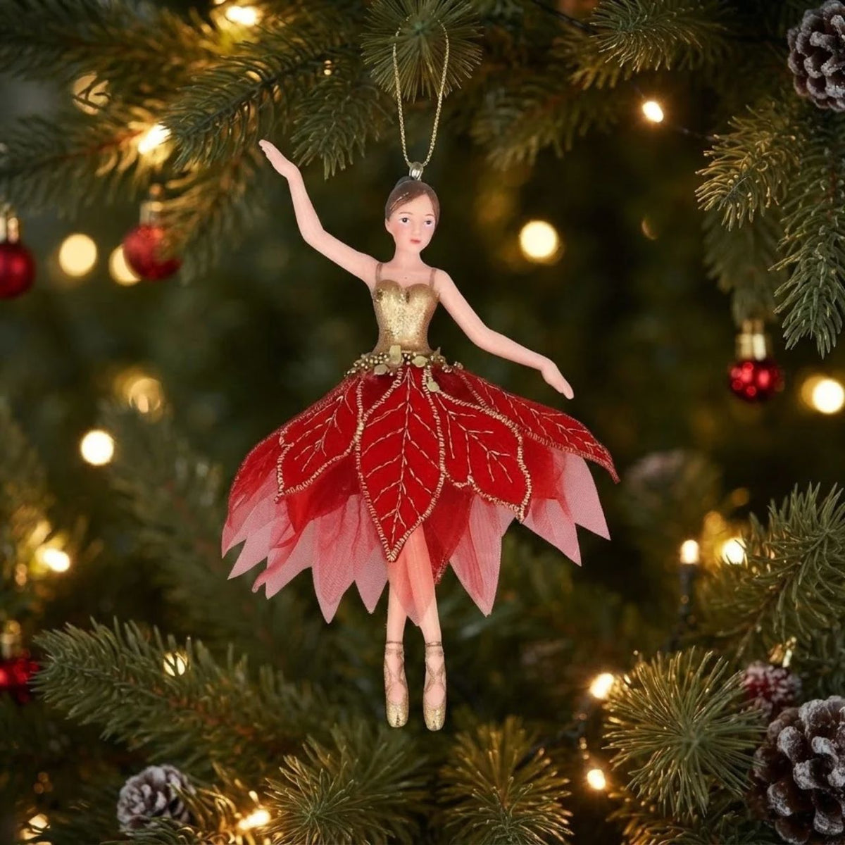 Bring festive elegance to your tree with this enchanting Gisela Graham fairy ornament. Dressed in shimmering gold with a poinsettia fabric accent, this charming hanging decoration captures the magic of the Christmas season. The delicate design makes it perfect for traditional or contemporary displays.