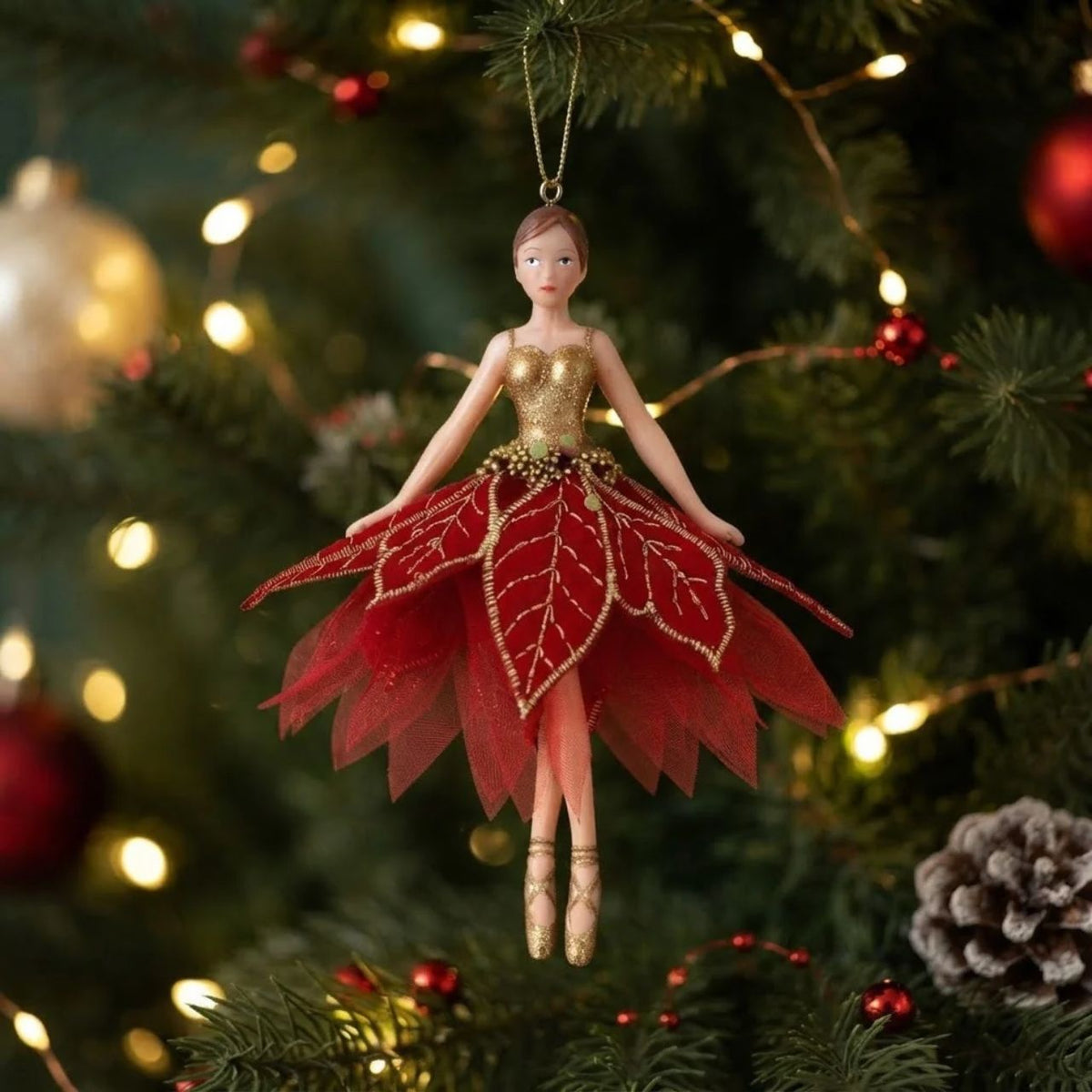 Bring festive elegance to your tree with this enchanting Gisela Graham fairy ornament. Dressed in shimmering gold with a poinsettia fabric accent, this charming hanging decoration captures the magic of the Christmas season. The delicate design makes it perfect for traditional or contemporary displays.
