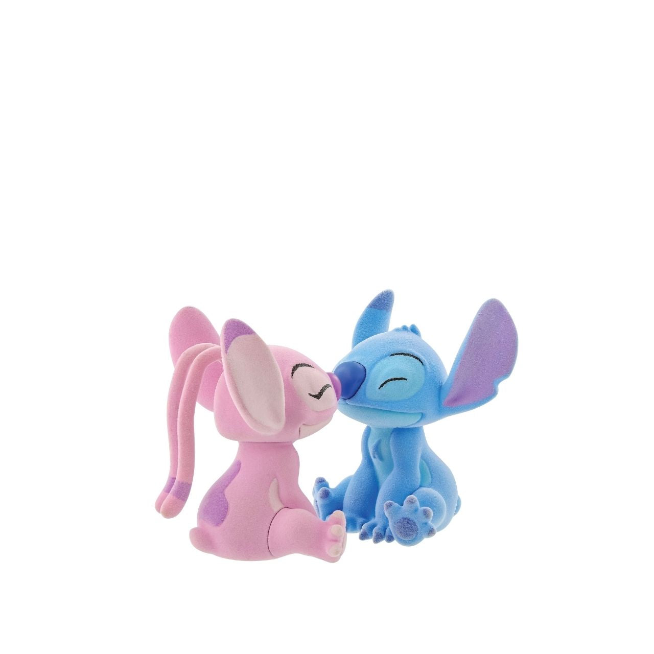 This dynamic duo are together again in this super cute flocked figurine pair. With magnets in their noses to pull them together, they look like they are having a sweet eskimo kiss.