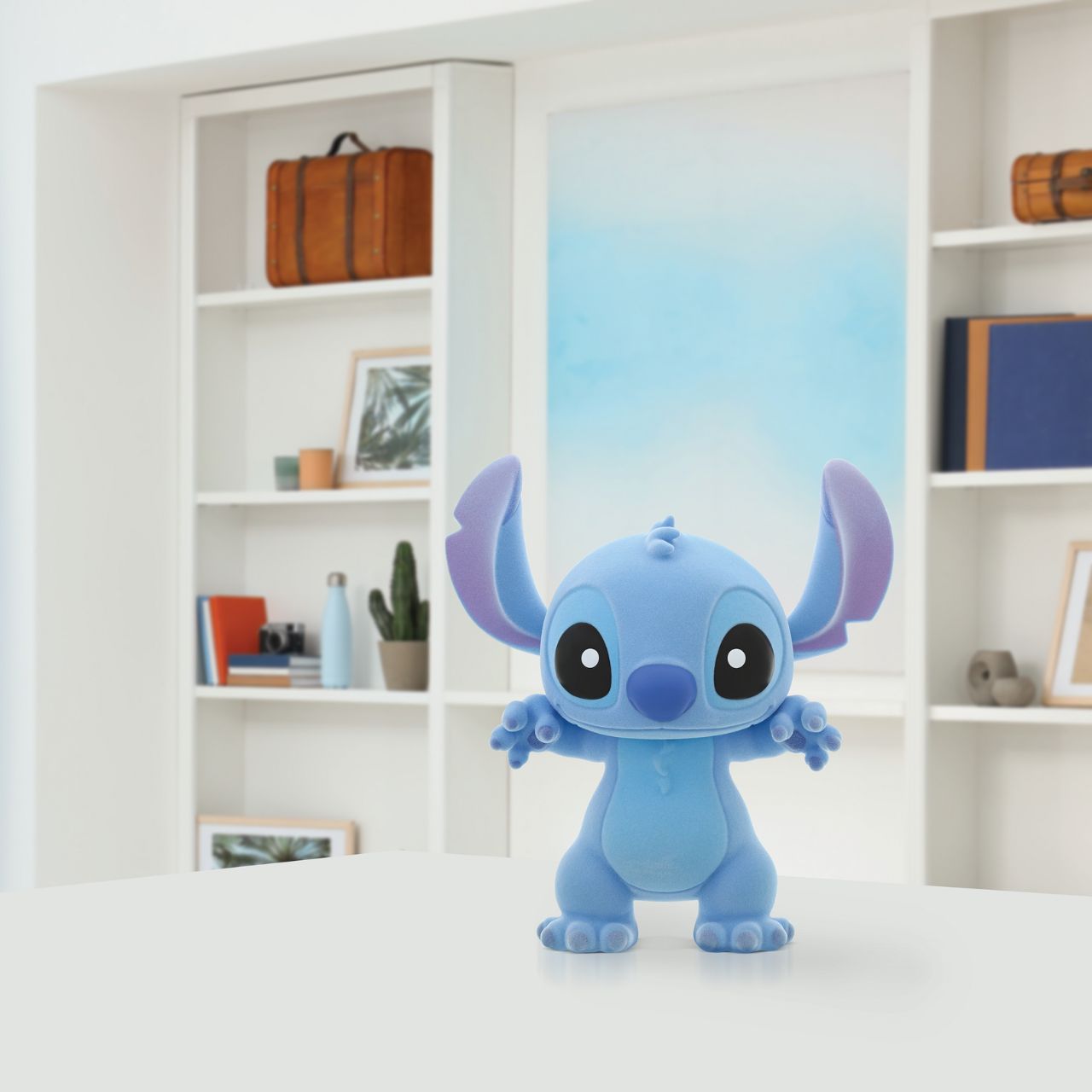 With his trademark blue fur and mischievous twinkle in his eye, this large flocked Stitch figurine is the perfect gift for any Disney fan.